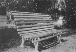 Bench in a city garden with an inscription 